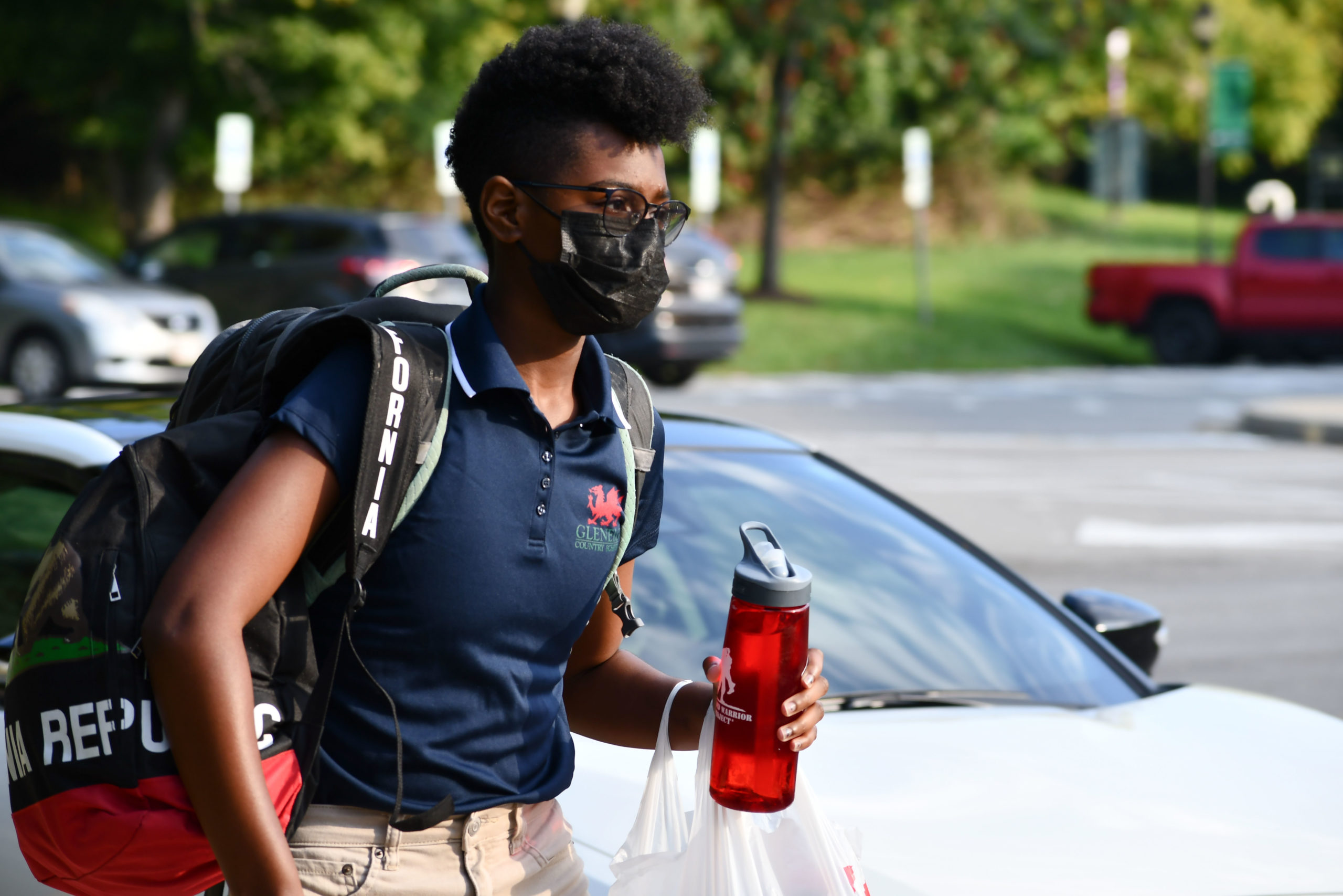 An Upper School student walks outside of the Upper School on the first day of school in September 2021.
