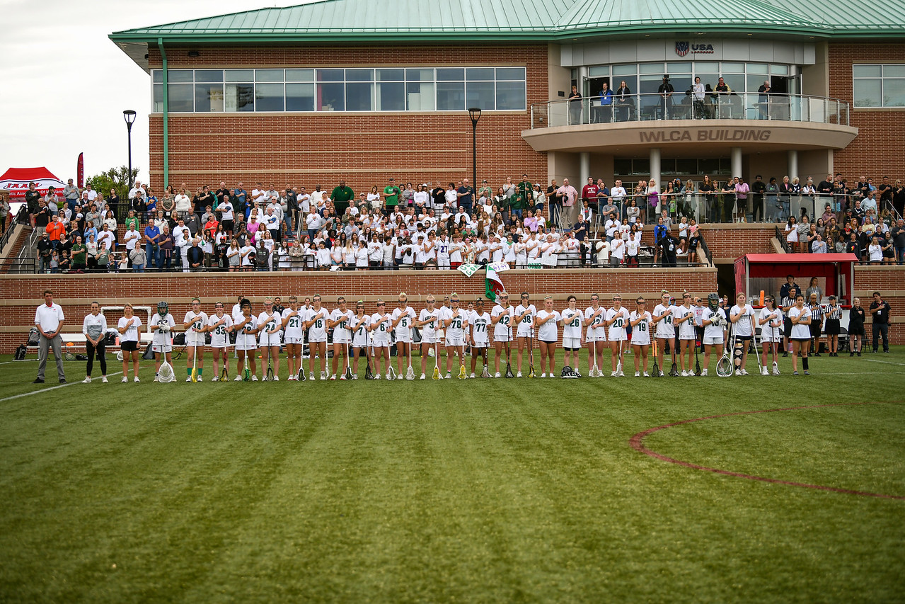 Varsity girls lacrosse team stands on the field before the IAAM A Conference championship.