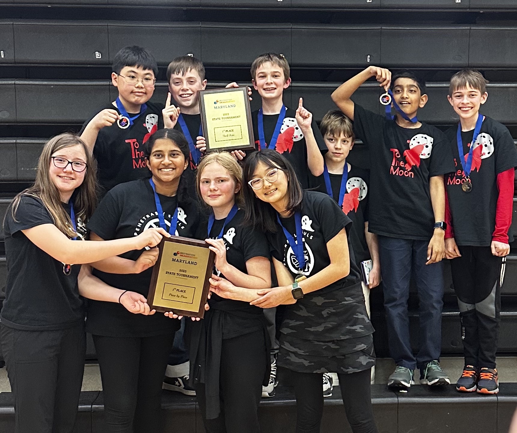 Middle School students in the Destination Imagination program hold up their awards.