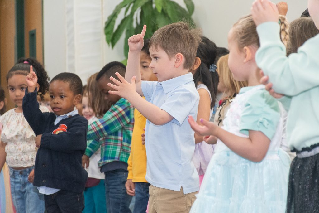 Preschool boys and girls performing a song.