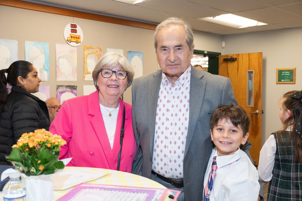 grandparents and their grandson pose for a photo.