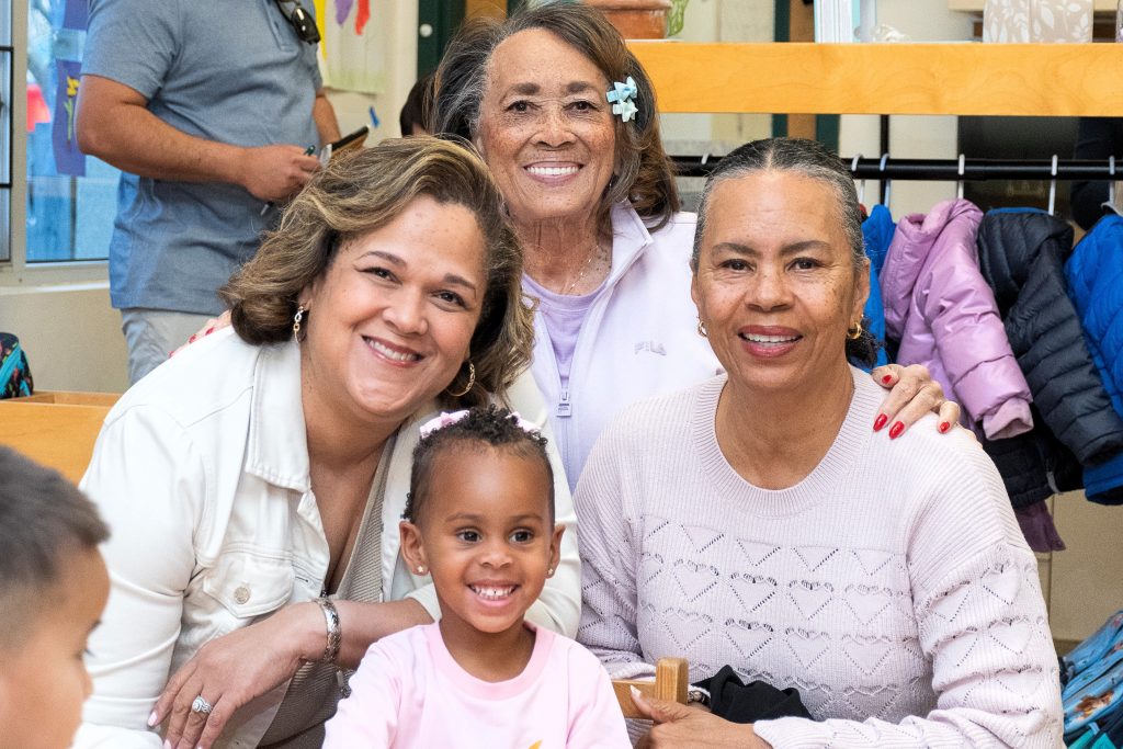 family memers pose with preschool student.