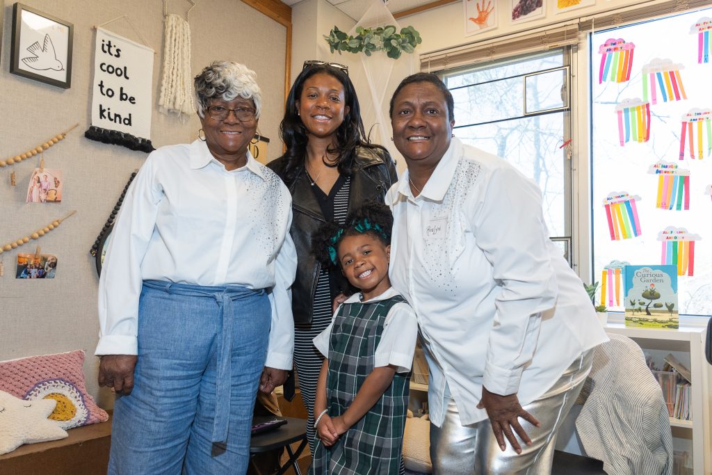 three family members pose with a student